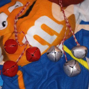 Christmas decoration: red and silver bells on cords to hang where ever